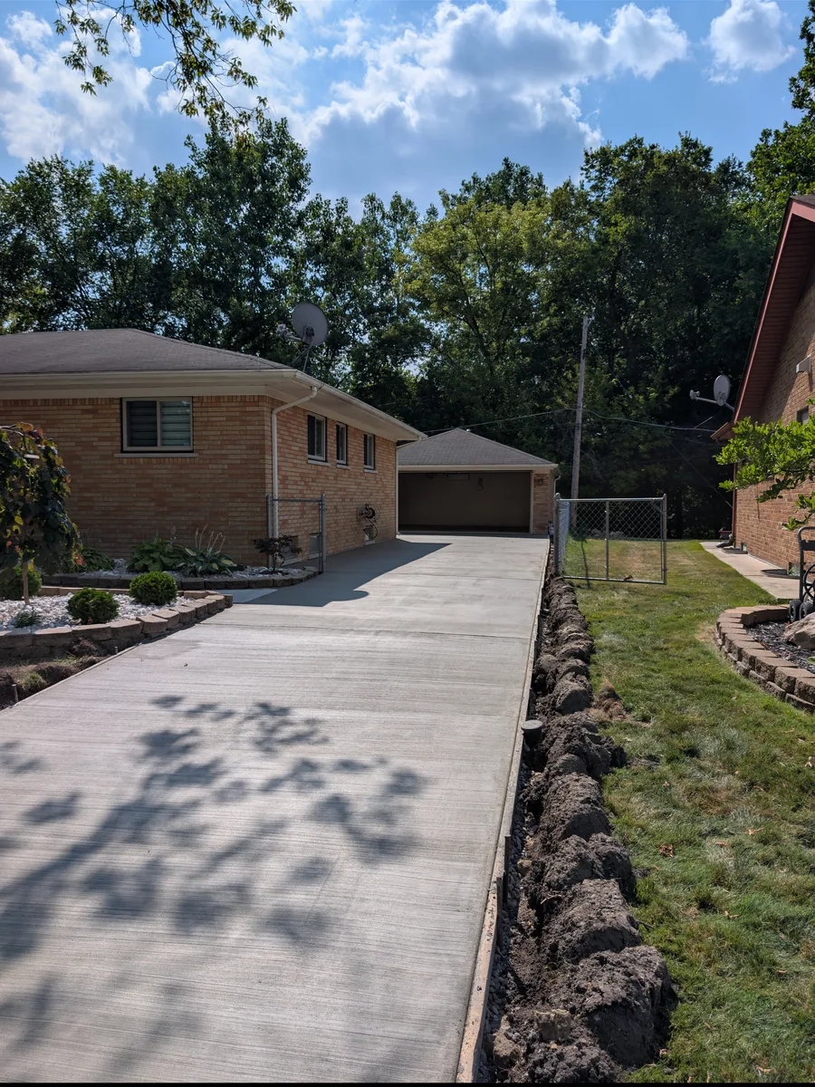 New broom-finish concrete driveway running to the detached garage, Dearborn Heights MI