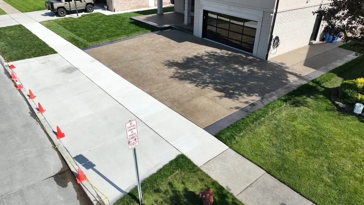 Exposed aggregate driveway with charcoal stamped border