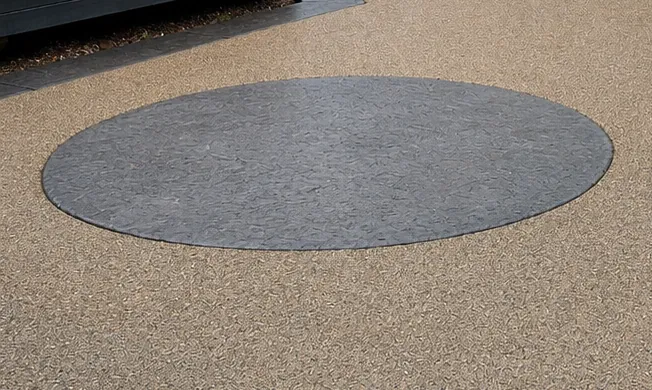 Charcoal circle inlay and curved stamped border on exposed aggregate pool deck, Troy MI