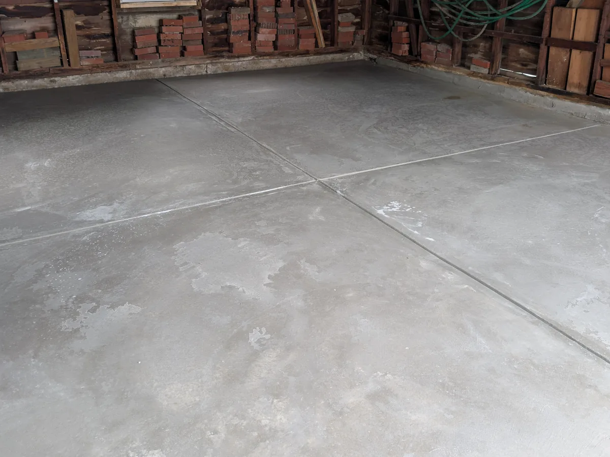 New garage floor slab with saw-cut control joints poured in one day for a certificate of occupancy inspection, Dearborn MI