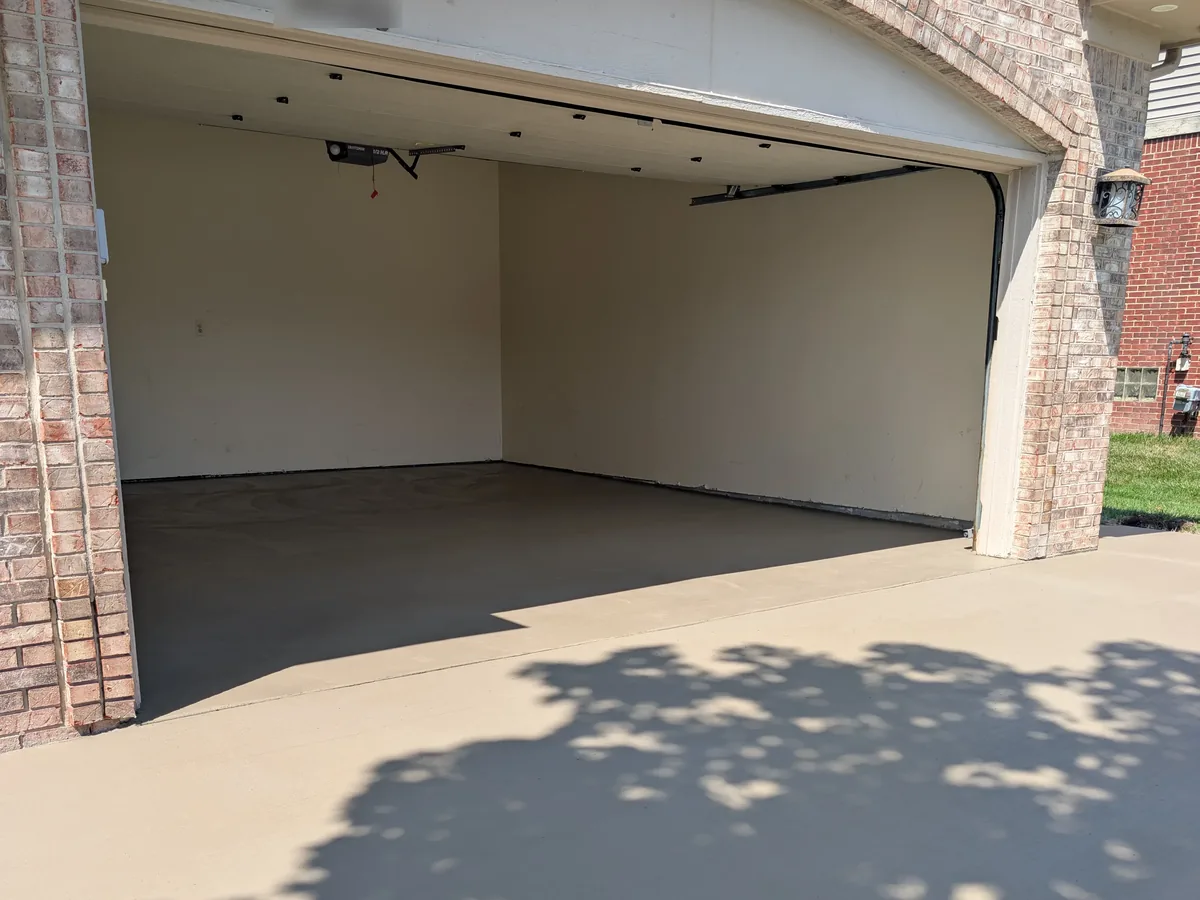 New steel-troweled garage floor slab poured level with the driveway apron, Livonia MI