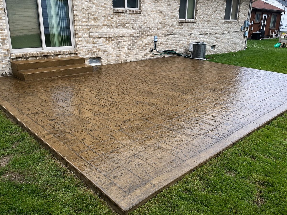 Tan brick-pattern stamped concrete patio with steps in Garden City, MI