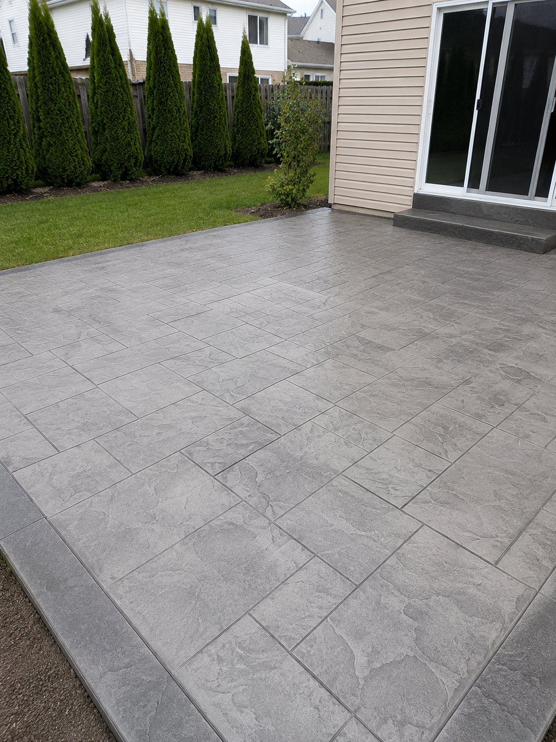 Large-format stamped concrete patio in slate pattern in Canton, MI
